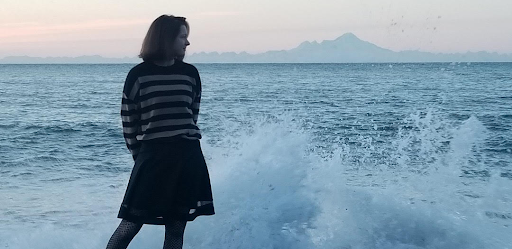 Simone Stanish stands in front of the cold ocean waves.