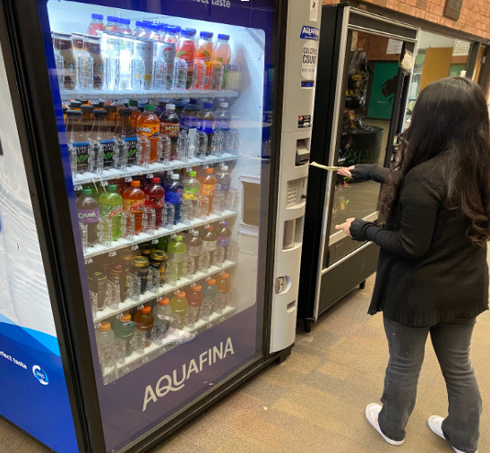Freshman Dafne Gonzalez buys a cold drink from the school vending machines after the last bell.
