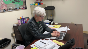 Tamra Astin works on tracking students attendance.
