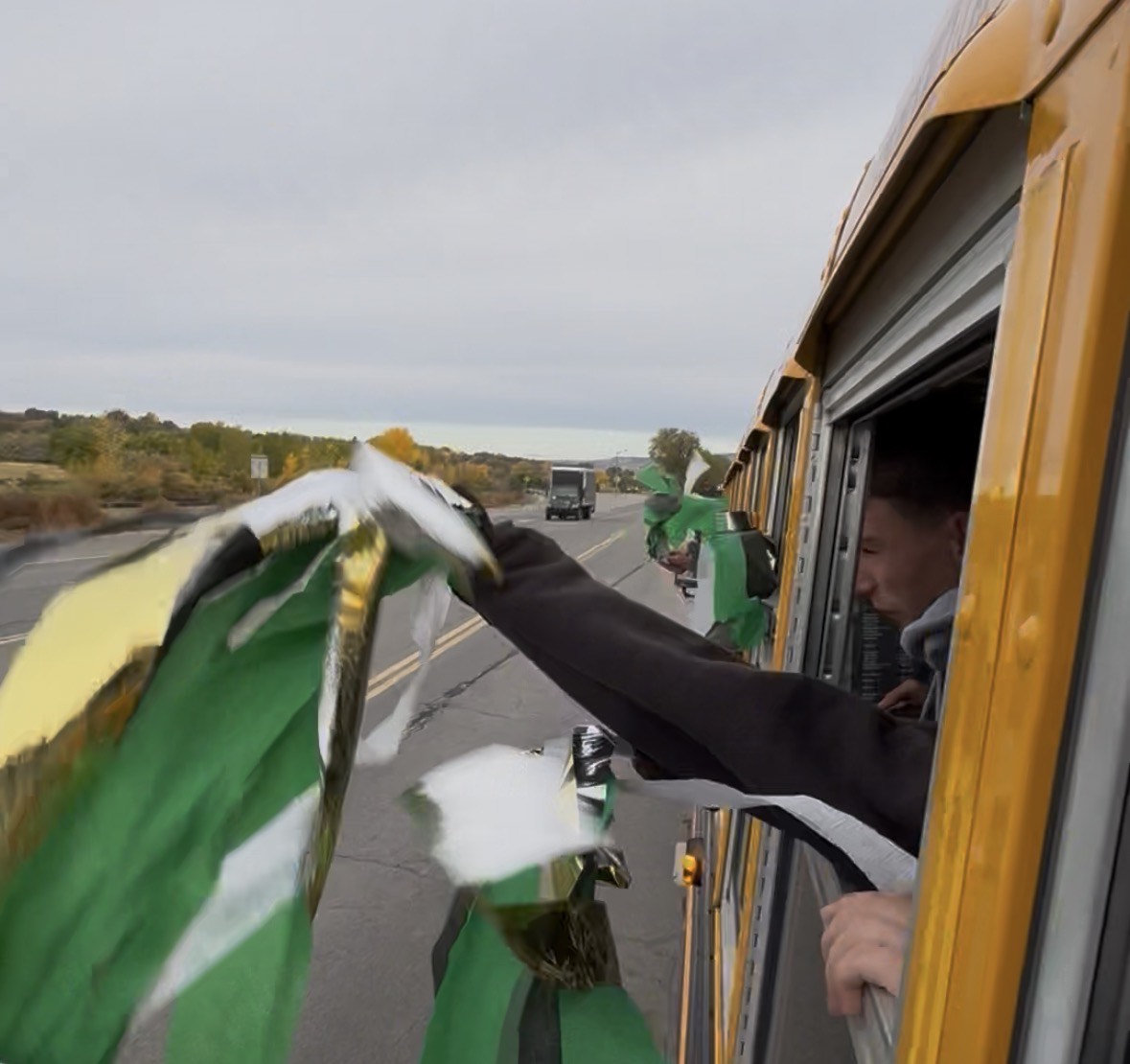 The band proudly waves a flag on the way to the State competition.